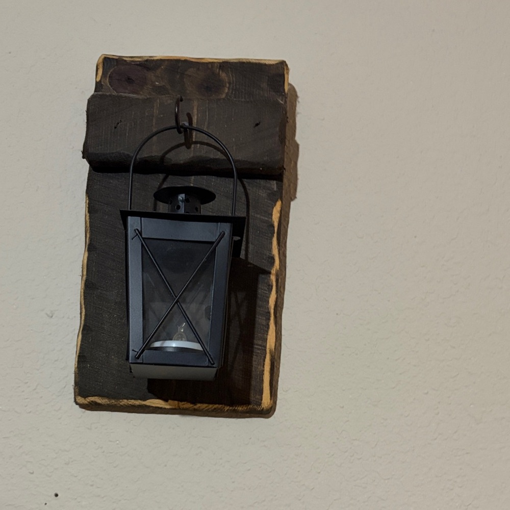 Black Wall Lantern Accent on Rustic Wood Backing